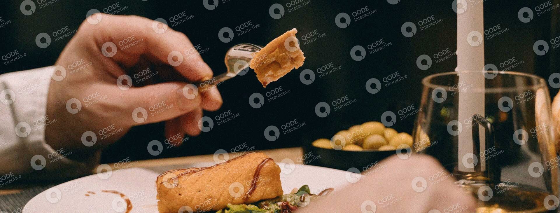 A hand holding a bite-sized piece of savory pastry.