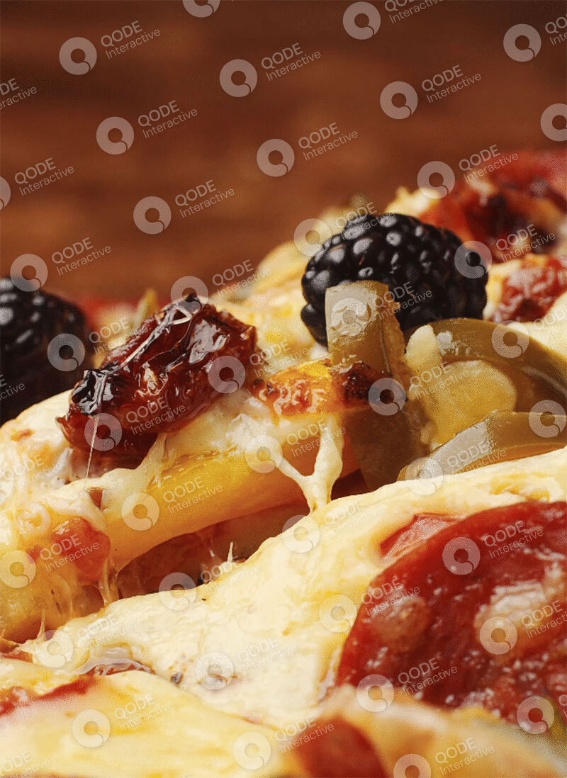 Close-up of a cheesy pizza slice with pepperoni and black olives.
