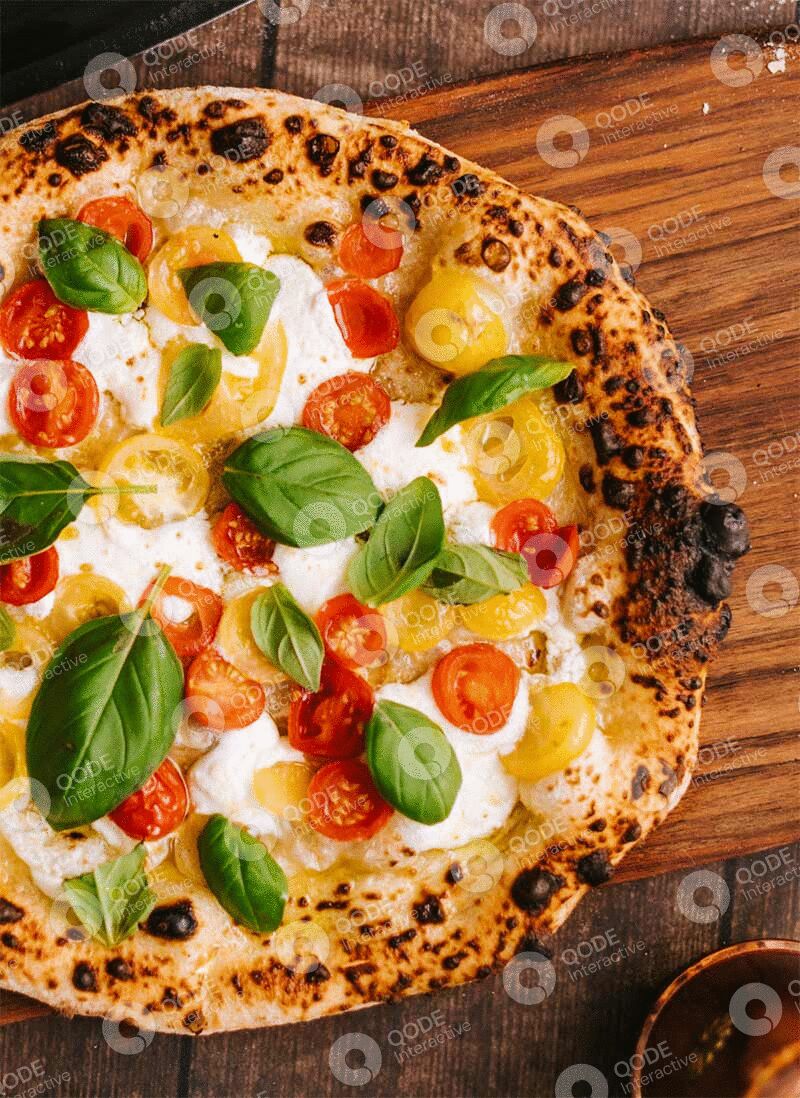 Fresh Margherita pizza with basil and cherry tomatoes.