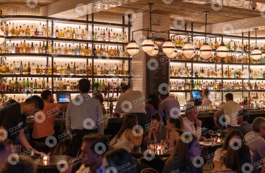 A cozy bar with patrons enjoying drinks and conversations.