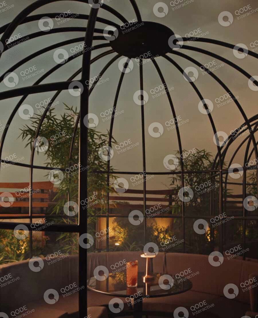 Cozy rooftop dining with candles and a decorative trellis at dusk.