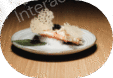 Gourmet dish with a creamy sauce and garnish on a white plate.