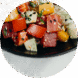 Colorful sushi rolls with various toppings on a black plate.