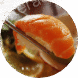Close-up of sushi with salmon and rice held by chopsticks.