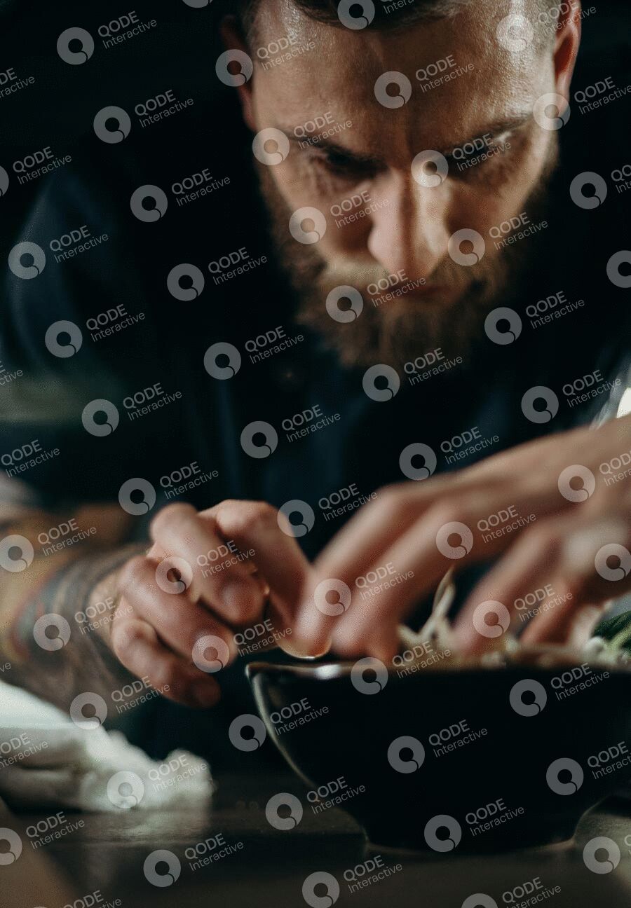 Focused man assembling a circuit board with precision.