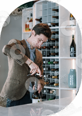 A bartender pouring a cocktail in a stylish bar setting.