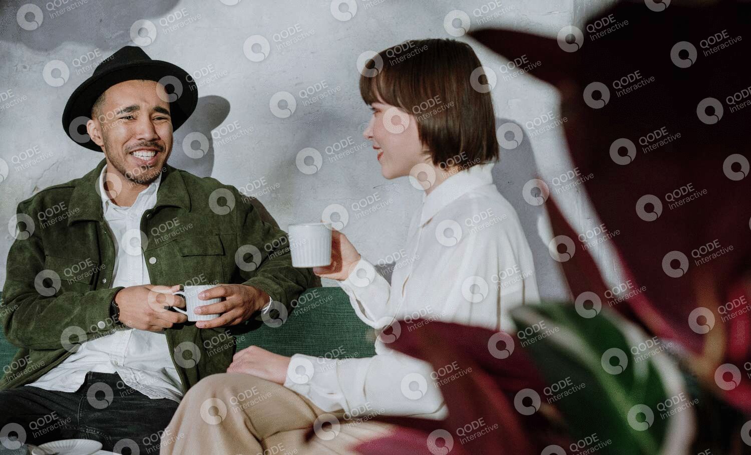 Two people enjoying coffee and conversation in a cozy setting.