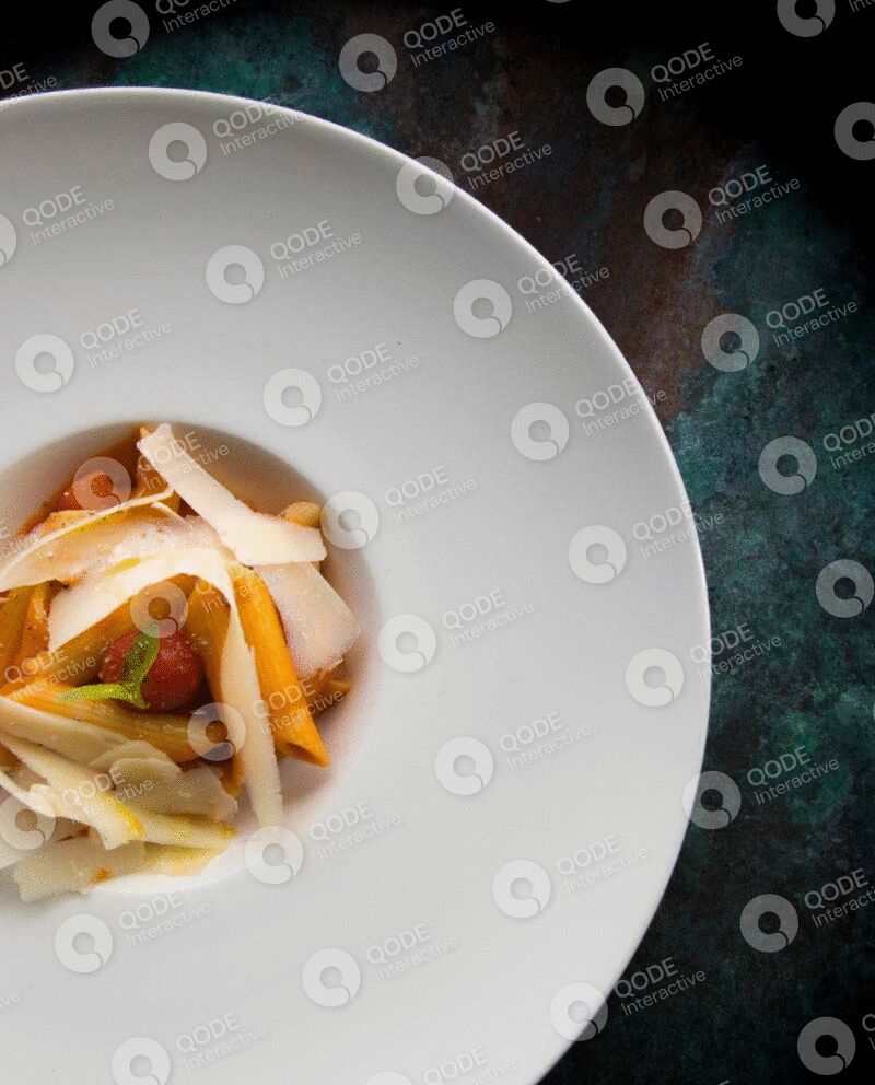 Gourmet dish with sliced mushrooms and vegetables on a white plate.