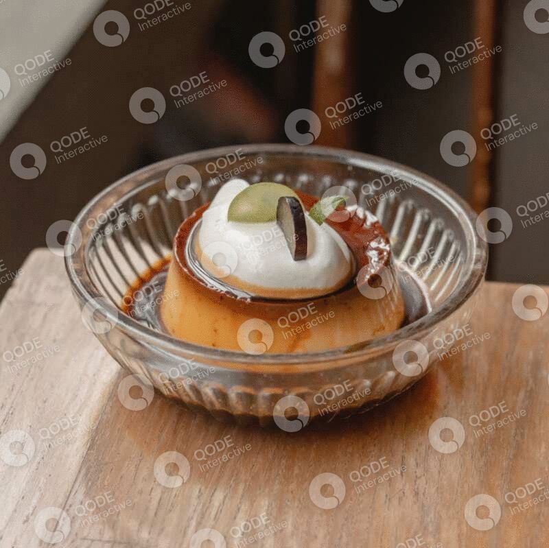 A caramel flan dessert topped with whipped cream and garnished with coffee beans in a glass bowl.