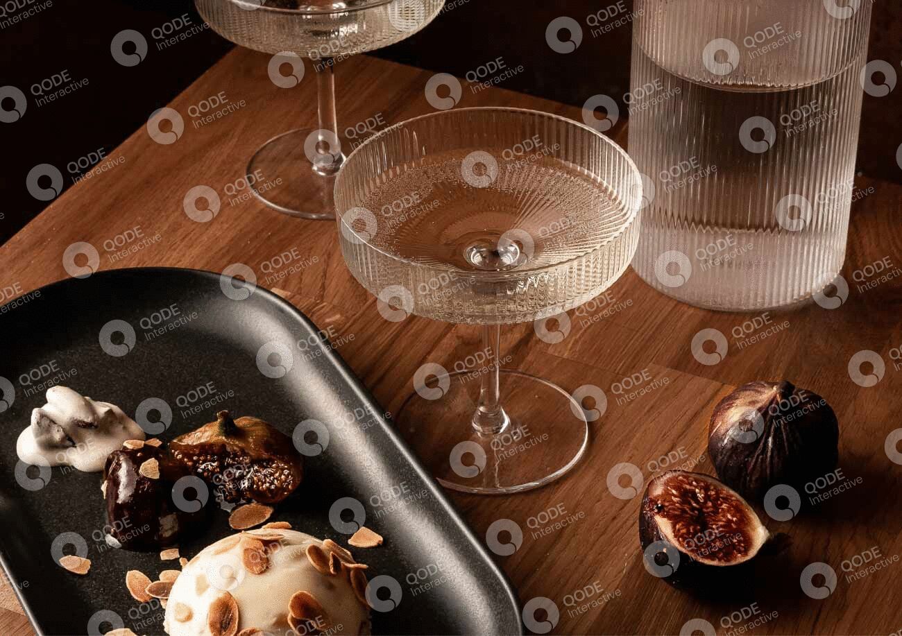 Elegant cocktail glass with coffee beans on a wooden table.