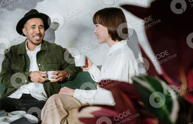 Two friends enjoying coffee and conversation in a cozy setting.