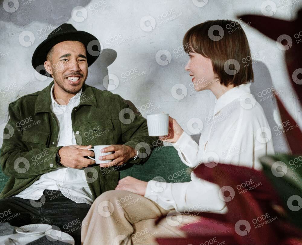 Two friends enjoying coffee and conversation in a cozy setting.