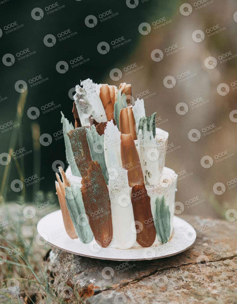 A rustic wedding cake with neutral tones and natural decorations.