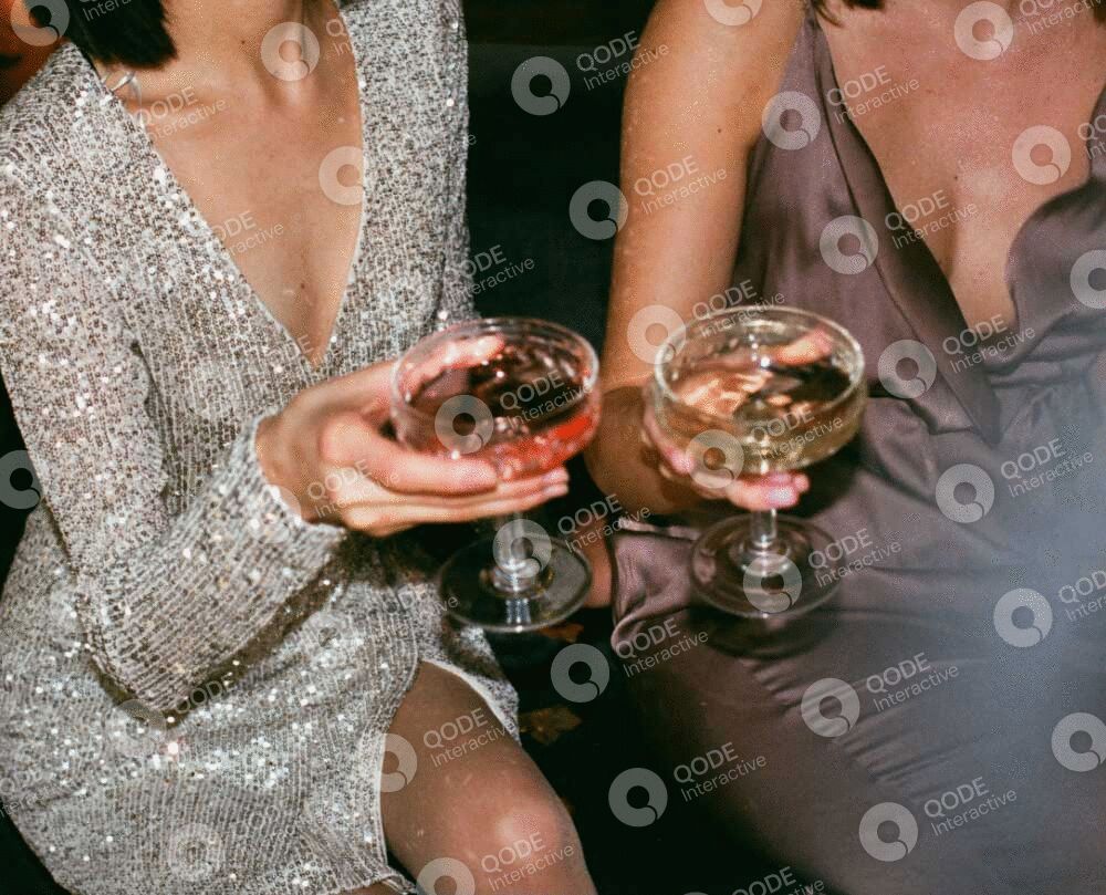 Two people clinking champagne glasses in celebration.