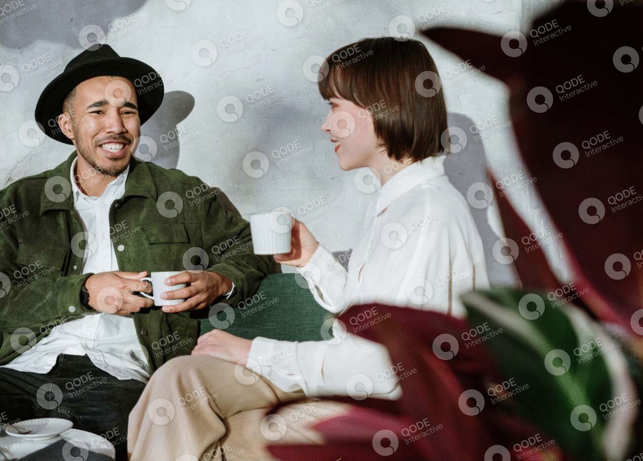 Two people enjoying coffee and conversation in a cozy setting.