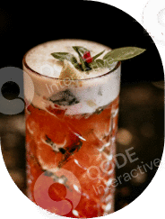 A refreshing cocktail garnished with herbs and a chili pepper.