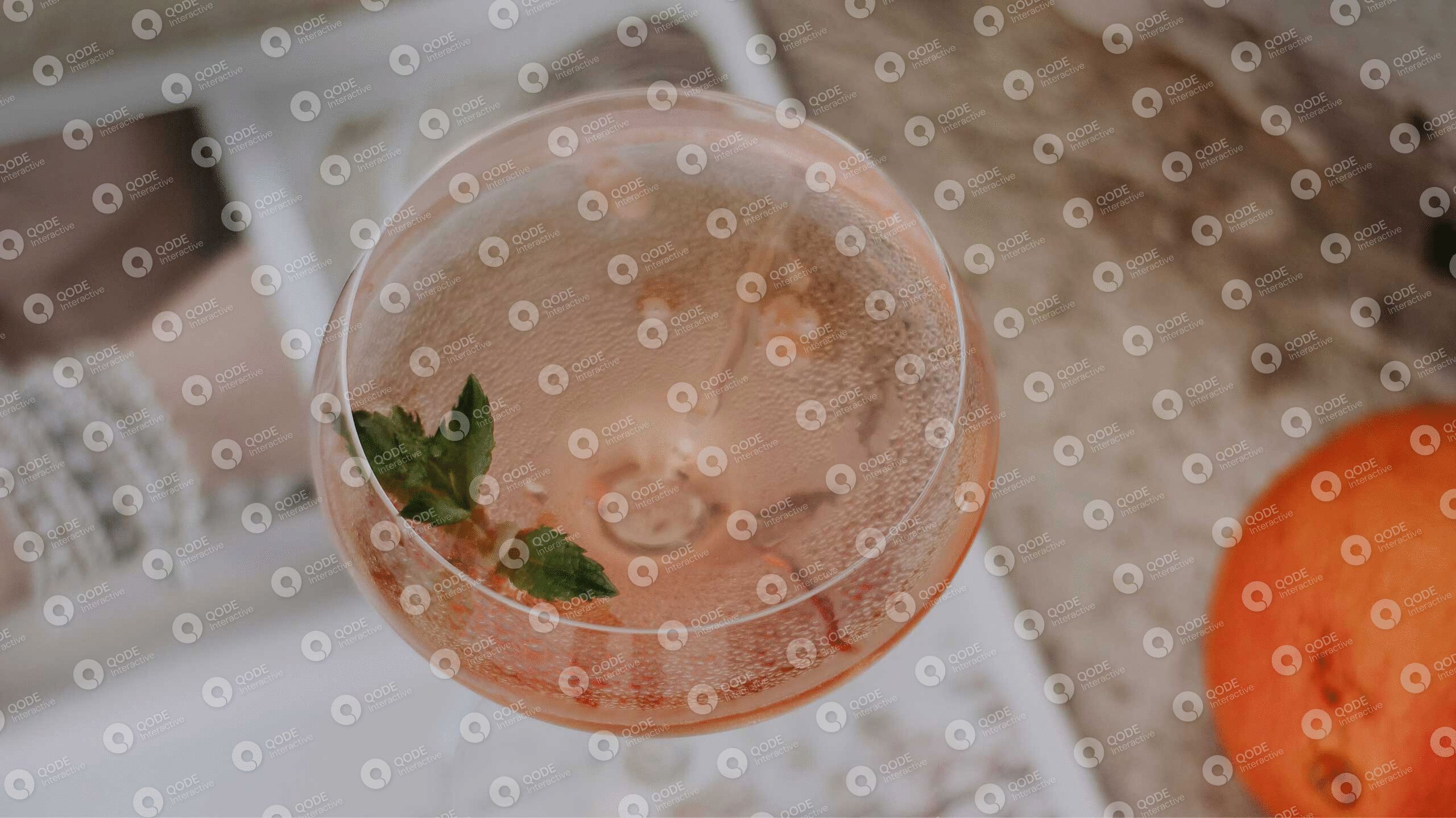 A refreshing cocktail garnished with mint leaves in a clear glass.