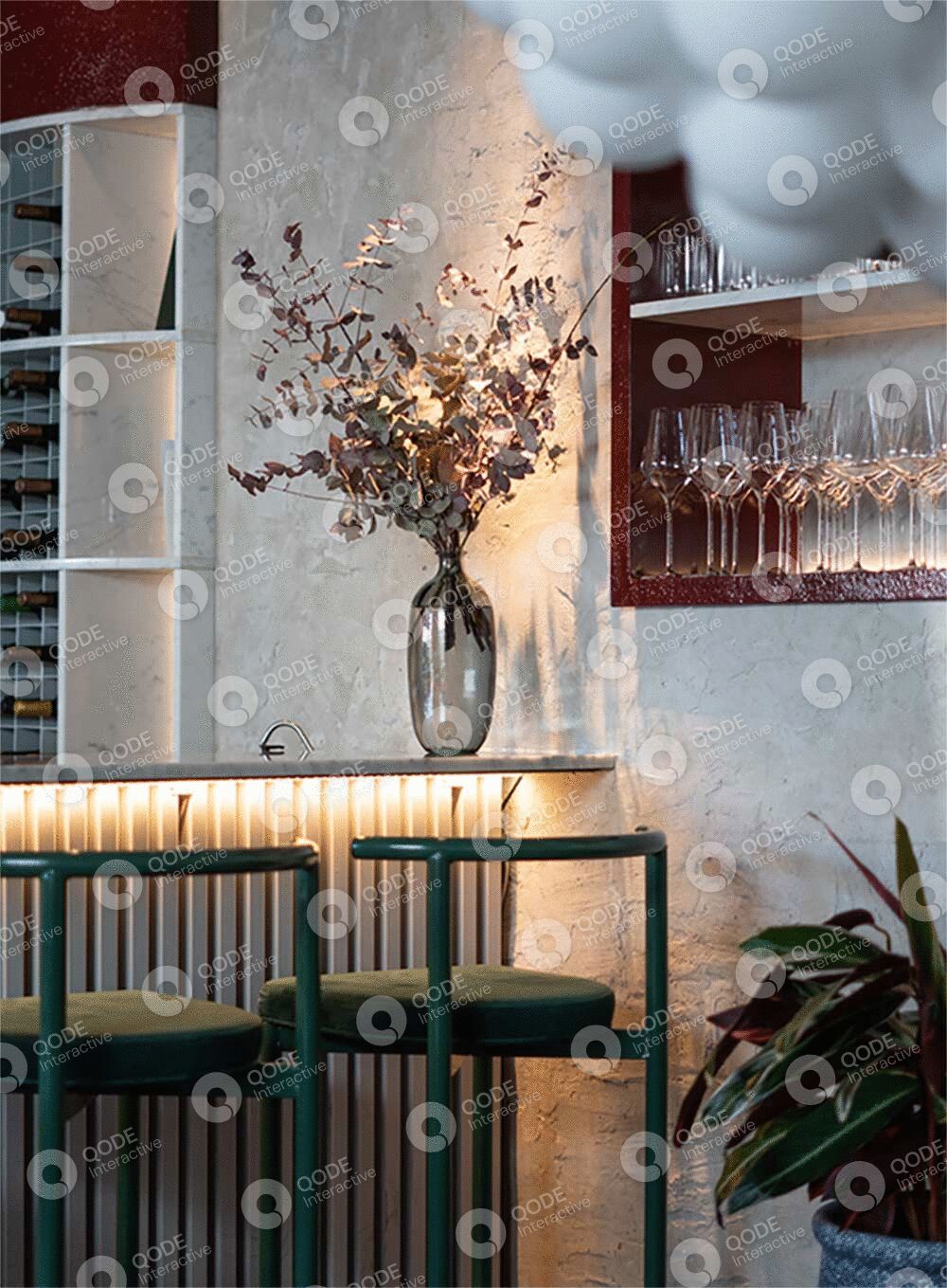 Elegant dining area with glassware and floral centerpiece.