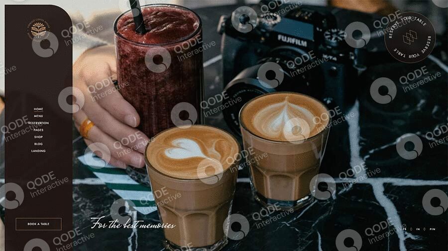 Two glasses of latte art coffee with a French press in the background.