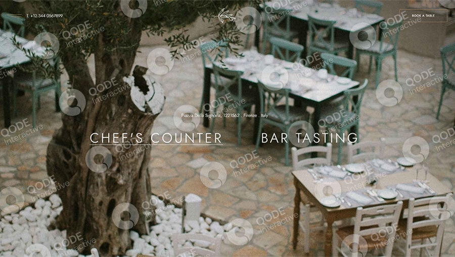 Cozy outdoor dining setup with wooden tables and chairs under leafy trees.