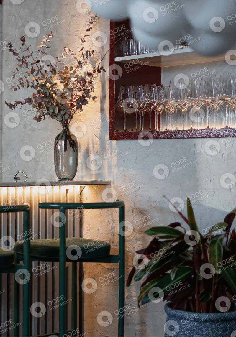 Cozy corner with dried flowers and wine glasses on a textured wall.