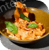 A bowl of creamy pasta garnished with basil and cherry tomatoes.