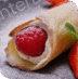 A close-up of a strawberry-filled pastry with a fresh strawberry on the side.