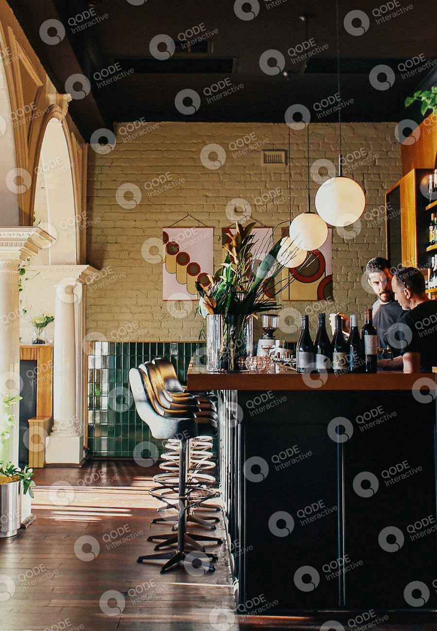 A cozy bar interior with patrons enjoying drinks and conversation.