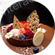 A colorful ice cream sundae topped with various fruits and wafers.