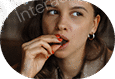 Young woman eating a snack thoughtfully.