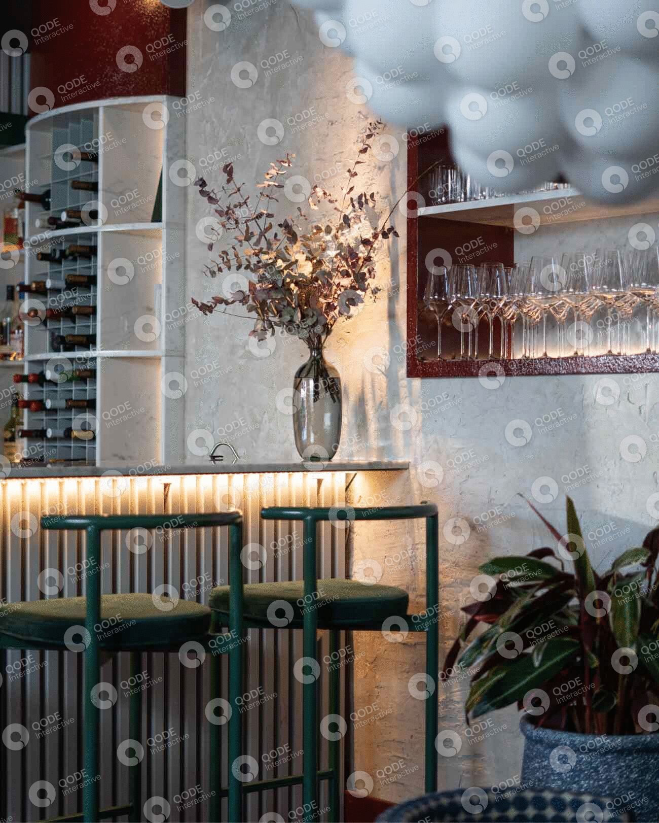 Elegant bar area with a floral centerpiece and modern lighting.