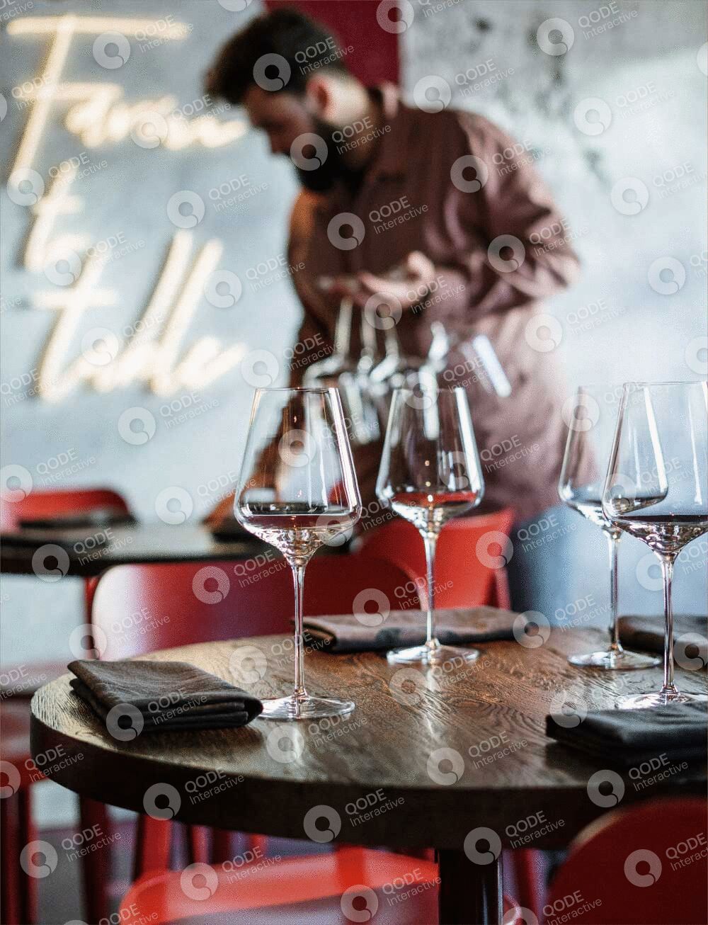 Elegant wine glasses set on a rustic wooden table with a blurred background.