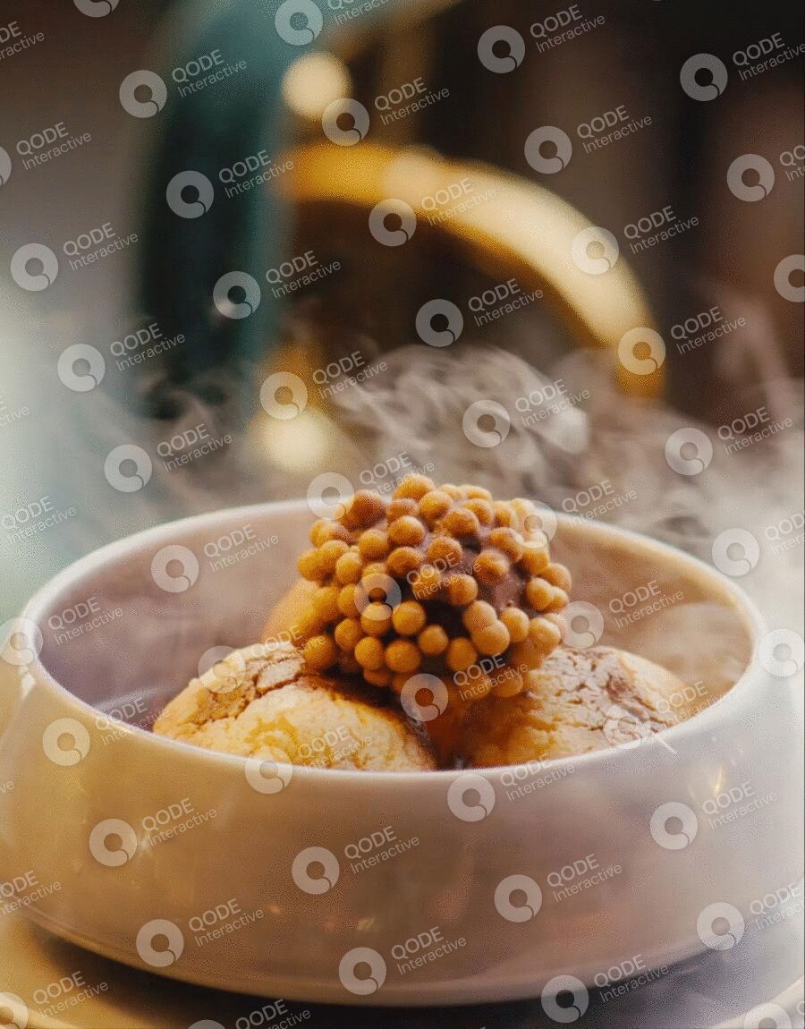 Steaming hot dessert topped with a cluster of small berries.