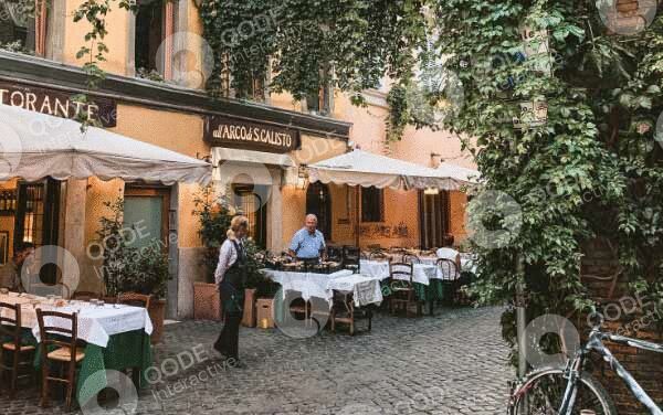 Outdoor restaurant seating in a charming, ivy-covered courtyard.