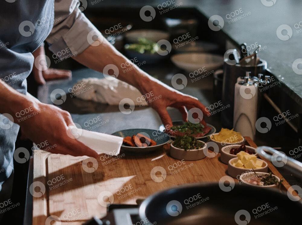 Hands preparing food with various ingredients on a kitchen counter.