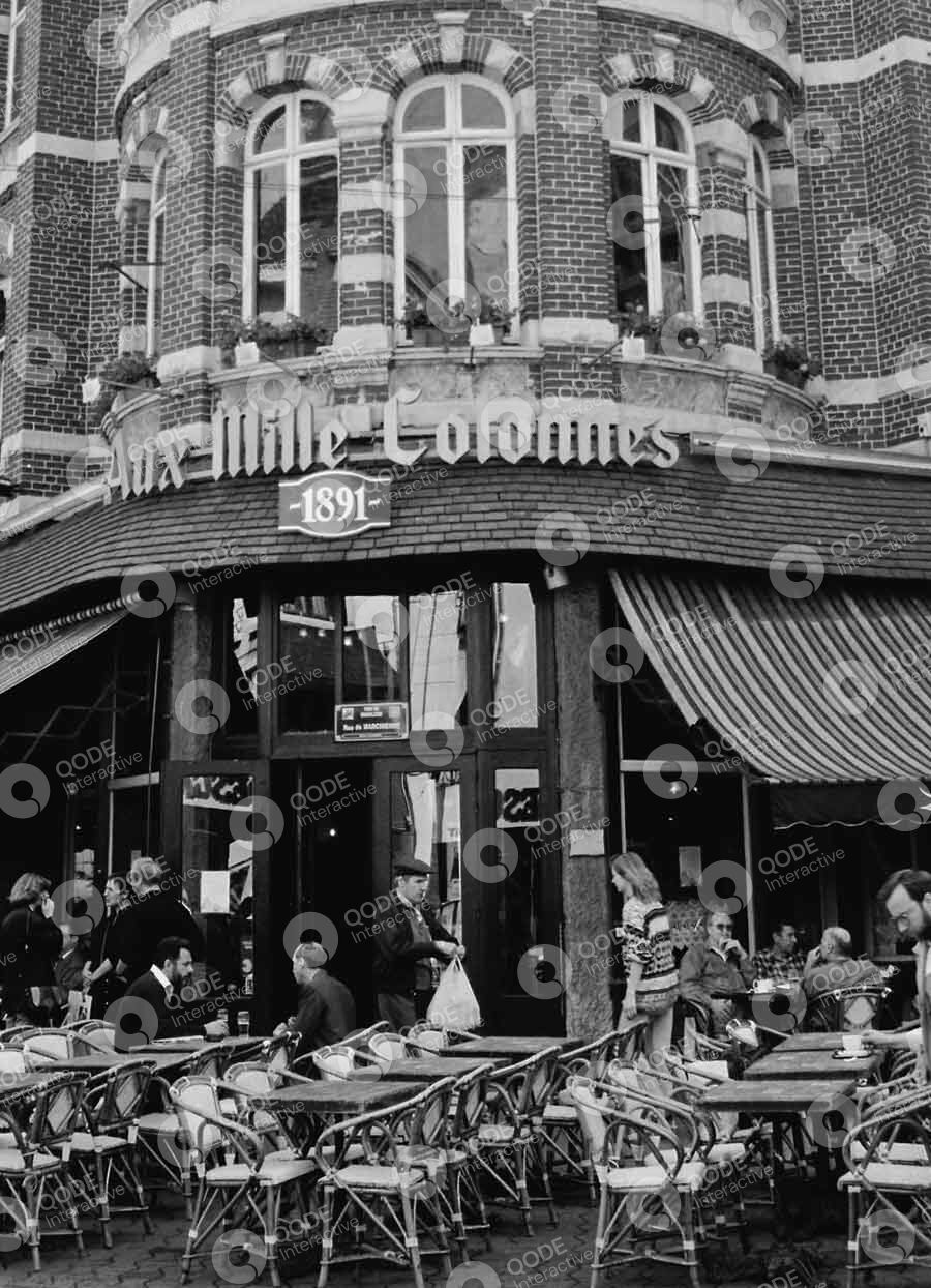 Bustling street scene outside a busy restaurant with vintage signage.