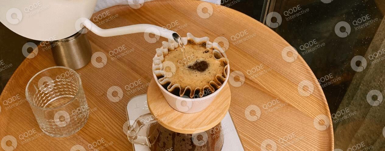 Freshly brewed coffee dripping through a paper filter.