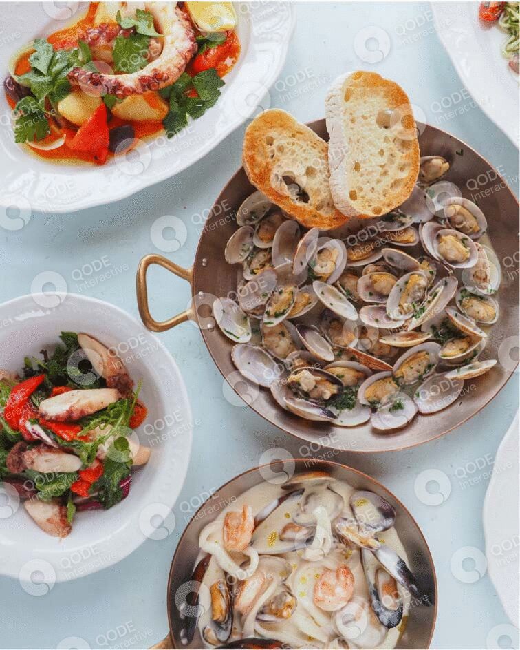 A seafood meal featuring clams with toasted bread and fresh salads.