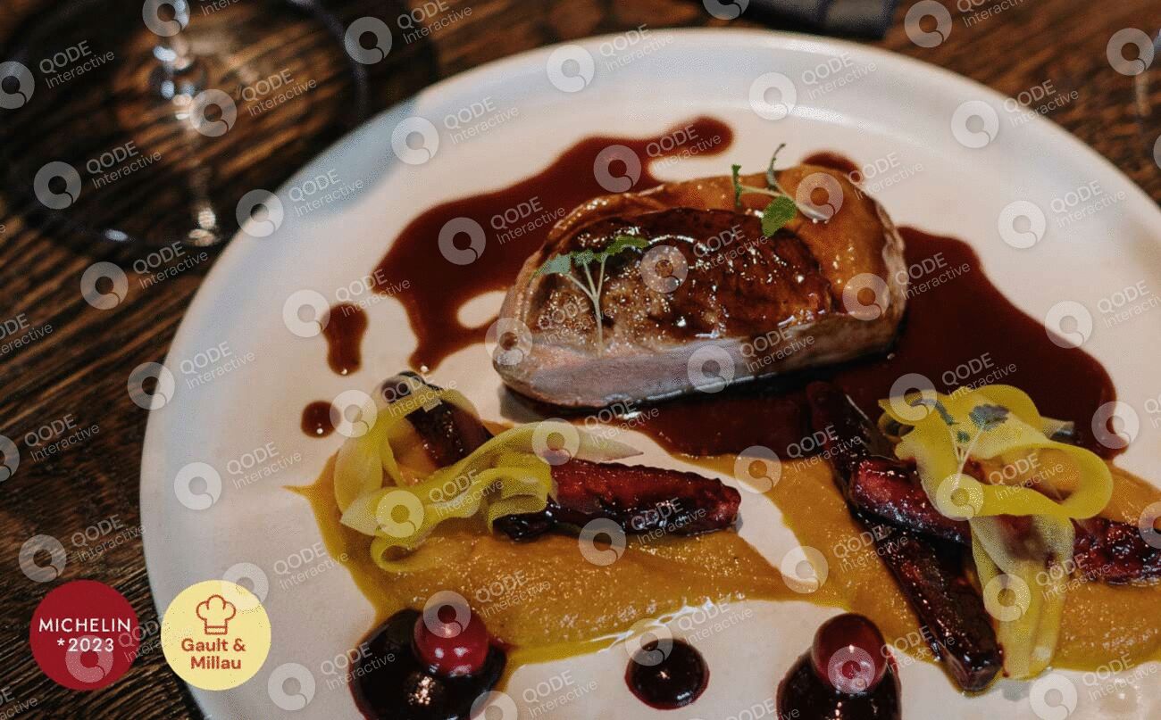 Gourmet plated dish with seared meat and artistic sauces.
