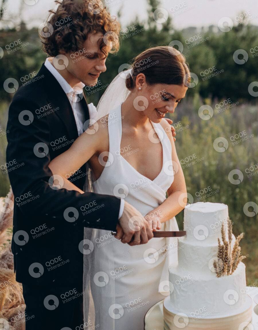 Bride and groom cutting their wedding cake outdoors.
