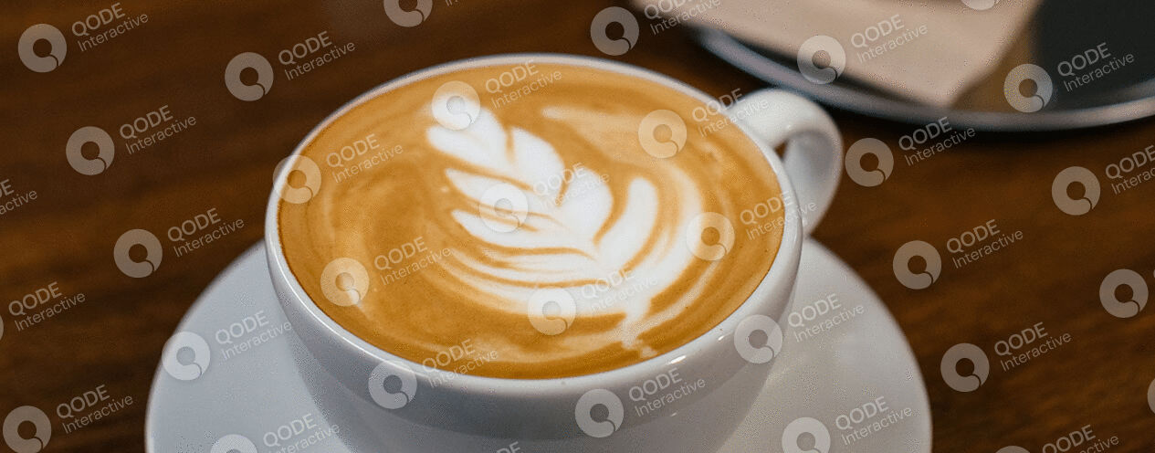 A cup of coffee with beautiful leaf latte art.
