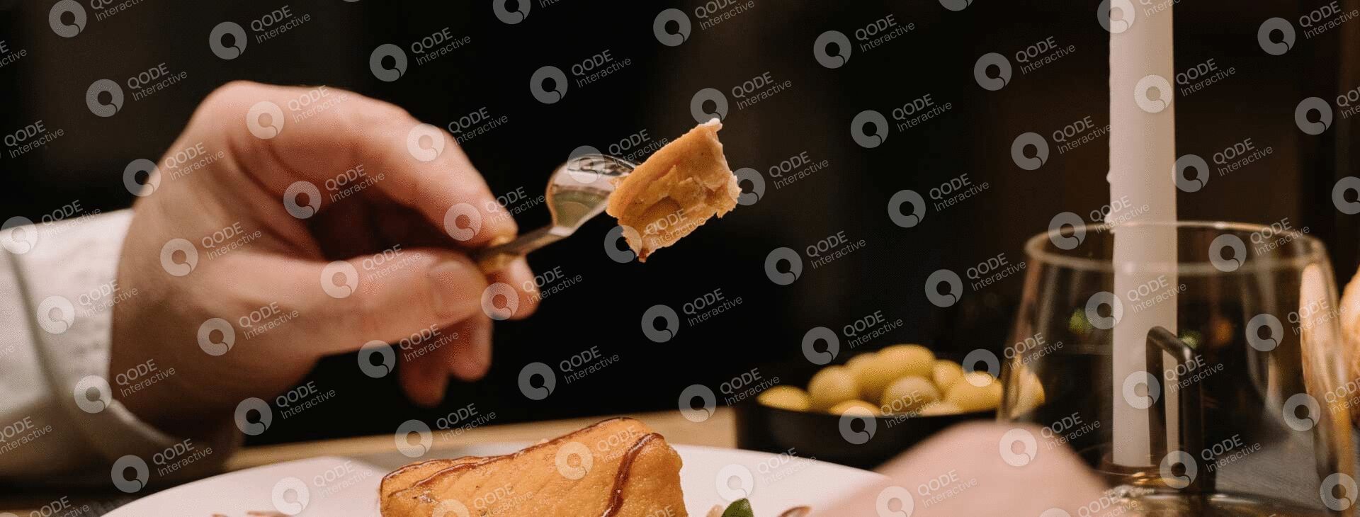 A fork lifting a piece of stuffed pasta with sauce.